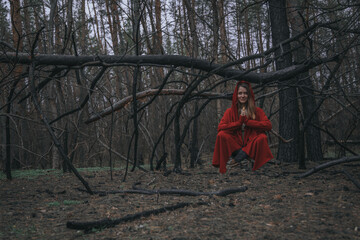 girl in red meditates in the air in nature. woman levitation