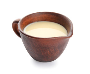 Gravy-boat with sweet condensed milk on white background
