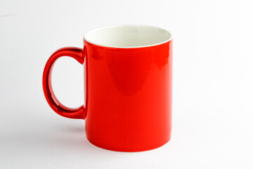 Red ceramic cup on white background.