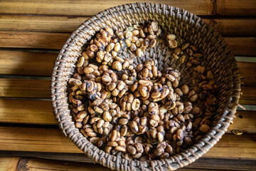 organic bags of a mature toasted a raw coffee beans put on a shelves at a warehouse