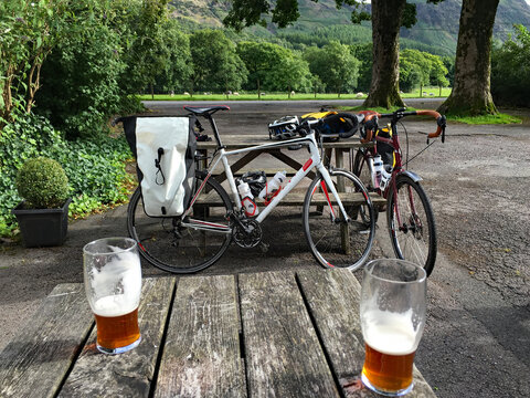 Pair of pints in pub beer garden in the Lake District well earned after a long cycle