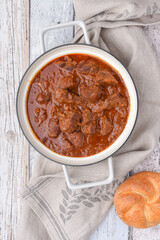 Viennese beef goulash on the wooden table