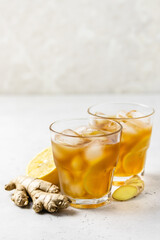 Festive summer drink, iced lemon ginger tea in glasses. Space for text.