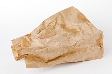 Crumpled paper bag with greasy spots on a white isolated background. Recycling of secondary waste
