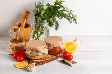 Homemade canned fish from mackerel in oil and tomato paste. Glass jars with canned fish