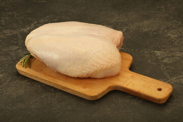Raw whole chicken breast with skin