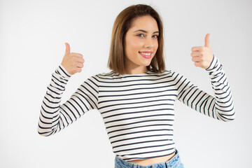 Smiling pretty young woman showing thumbs up isolated over white background