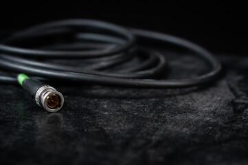 bnc connector for transmitting video and audio signal in filmmaking on a dark background