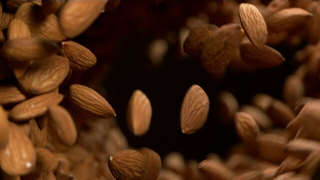 Super slow motion of flying almonds in rotating movement. Filmed on high speed cinema camera, 1000fps.