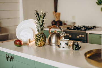 Healthy breakfast, a glass of fresh grapefruit, mango, pineapple white dishes, coffee tea. Soft selective focus.