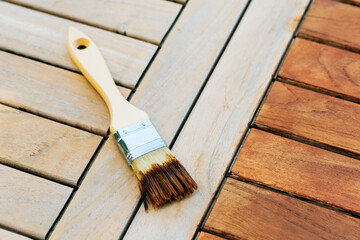 paintbrush on a renewable exotic wooden garden table - for background