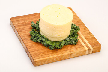 Yellow round dairy soft cheese