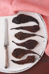 Dried pears on the serving board with knife