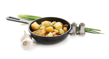 Frying pan of tasty potato with garlic on white background