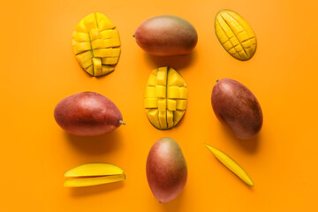 Sweet ripe mangoes on color background