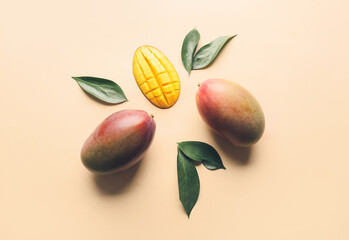 Sweet ripe mangoes on color background
