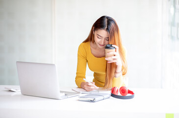 Portrait of smiling beautiful business asian young woman working in office use computer with copy space. sme freelance online marketing e-commerce telemarketing, work from home concept