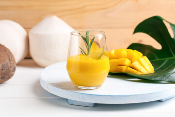 Glass of tasty mango margarita on table