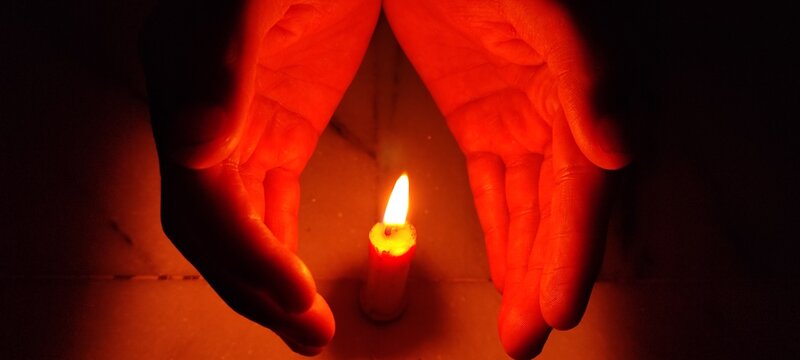 candle light sefty hands background