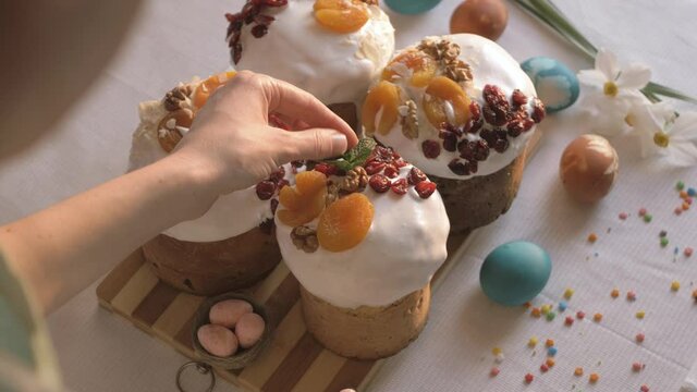 Preparing Easter cakes for the holiday. Happy Easter. Decoration sweet dry fruits. Easter cake and eggs happy holidays festive table setting traditional and treats on the table.