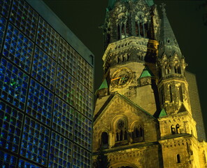 Contrast between the Remembrance Church and the Kaiser Wilhelm Memorial Church, illuminated at night, Kurfurstendam, Berlin