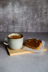 Breakfast of toasts with cocoa cream and cup of coffee with milk and cinnamon