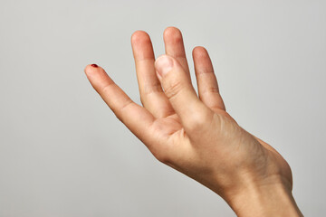Woman finger with blood drop for diabetes test.