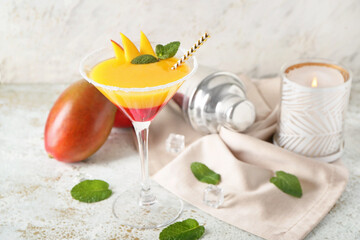 Glass of mango margarita on light background