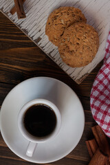 A mug of aromatic coffee with Russian gingerbread. On a wooden table. Coffee break. Coffee. Rustic still life. 