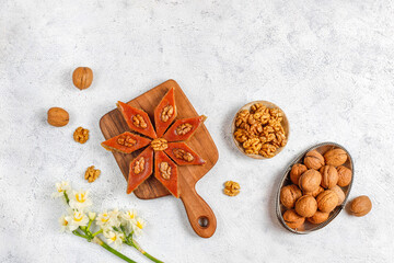 Traditional Azerbaijan holiday Novruz cookies baklava on the light  background with nuts and shekerbura,qogal,mutaki,flat lay,top view,space for copy