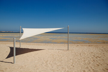 white beach awning on the Red Sea and blue sky