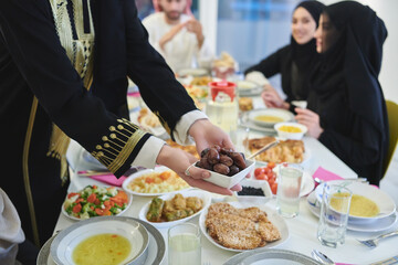 Muslim family starting iftar with dates during Ramadan