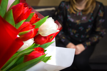 DEFOCUS Tulip women background. Bouquet of colorful tulips with blurred woman on background Happy Mother's Day concept. Women's day. Horizontal. 8 march. Focus on foreground. Out of focus