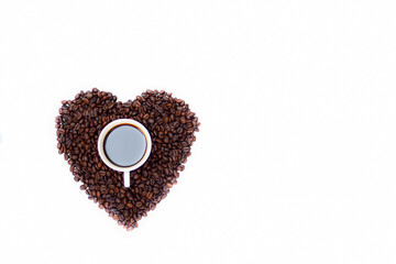 Black coffee in a white cup Placed in roasted coffee beans The pile is heart-shaped On a white background, coffee lover, espresso shot, background coffee