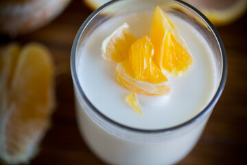 homemade sweet yogurt in a glass with oranges
