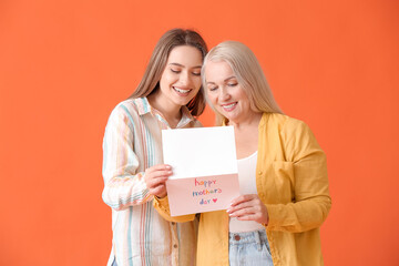 Young woman greeting her mom on Mother's Day against color background