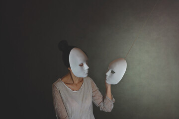 woman with mask chooses another mask of herself, the concept of introspection