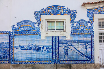 Obraz premium External view of Historic building of old Aveiro Railway station ornamented with typical blue azulejos tile exterior, which tells a story of life in traditional Portugal. Aveiro, Portugal.