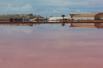 Scenic view of old salt factory and mirror-like salt pool in regional reserve of las Salinas y Arenales de San Pedro del Pinatar, Murcia, Spain