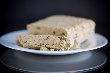 piece of sweet halva on black background