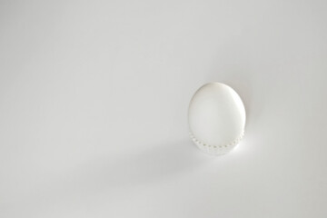 Fototapeta na wymiar White egg on a white isolated background with shadow. Ingredient.Healthy food.Easter.