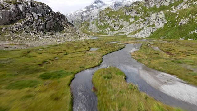 Aerial view of river in a grassy plain in Greina, Switzerland 2