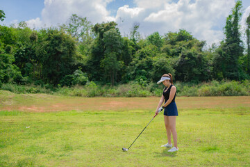 Portrait of golfer asian woman holding golf wood at the country club,Happy woman concept