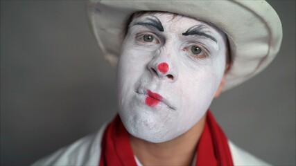 Mime is fooling around on camera.. Funny mime touching his beard