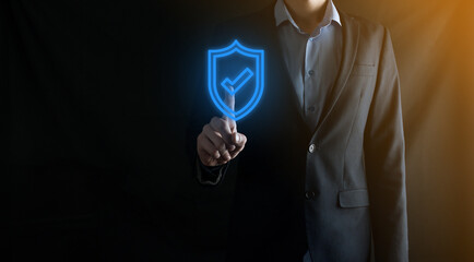 Protection network security computer in the hands of a businessman. business, technology, cyber security and internet concept - businessman pressing shield button on virtual screens Data protection