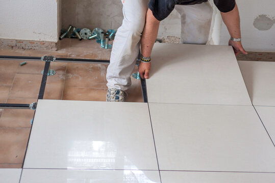 Worker who creates a floating raised floor. Selective focus