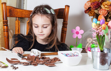 Little girl with chocolate egg.