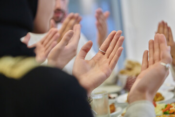 Fototapeta premium Muslim family making iftar dua to break fasting during Ramadan
