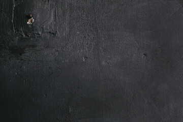Naklejka premium Dark black grunge textured wall closeup macro