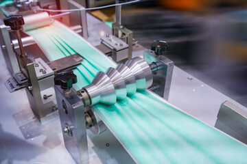 non woven material on automatic machine for the manufacture of medical masks with nanofiber. Coronavirus and Covid-19 Protection